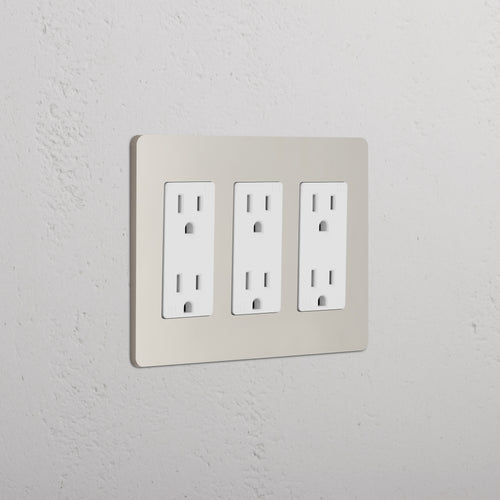 Grove 3G Outlet in polished nickel with a white cover plate, shown mounted on a white textured wall.