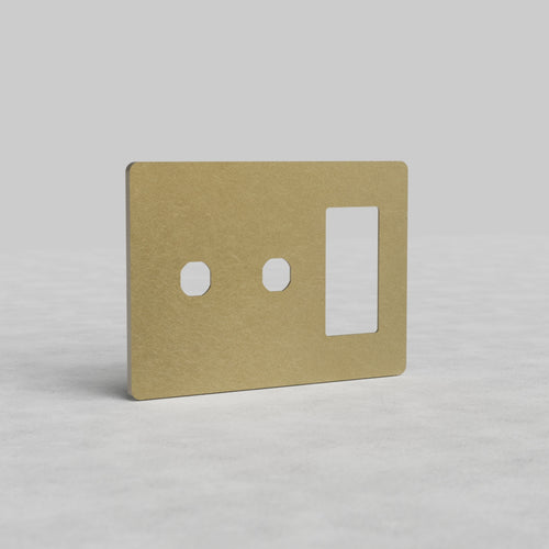 Antique brass 3G 2x switch and outlet plate, Grove US style, with two switch cutouts and one outlet opening.