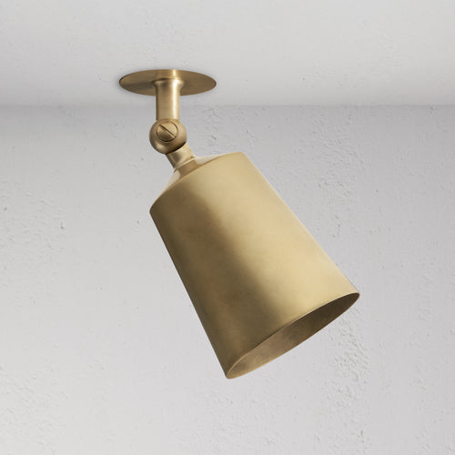 Perryn Single 70mm Spotlight in Antique Brass, ceiling-mounted with angled cone-shaped shade.