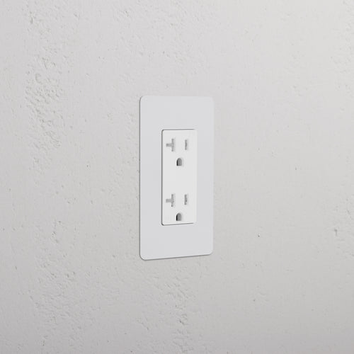 Kew 1G 20A electrical outlet with paintable white rectangular faceplate, installed on a wall.