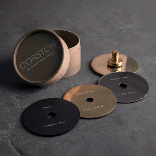Sample Finish Set box with lid off, showing four labeled metal finish discs and a matching fixture piece.