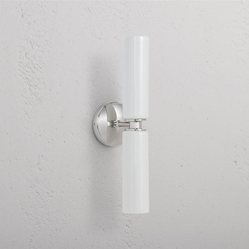 Claremont Medium Wall Light Fine Porcelain in polished nickel with twin vertical white porcelain shades.