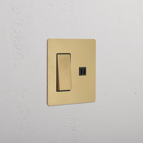 Kew 2G Rocker Switch & Fast Charge USB in antique brass black finish, shown on a white textured wall.