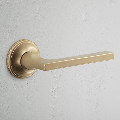 Clayton Dummy Door Handle Set in Antique Brass with a modern rectangular handle on a round base.