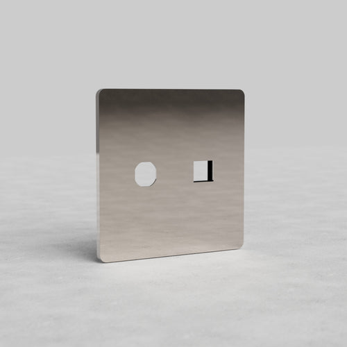 Polished nickel 2G Switch & Keystone Plate Grove US with hexagonal and rectangular openings on gray surface.