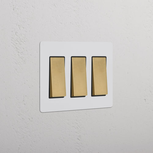 Kew 3G Rocker Switch in paintable antique brass black finish, featuring three black rocker switches.