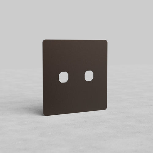 Bronze 2G Switch Plate Kew US with two switch apertures, shown on a light, textured surface.