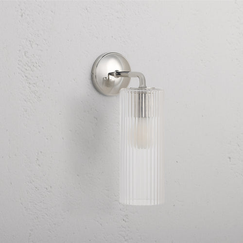 Large Claremont Wall Light with fluted glass shade and polished nickel base, mounted on a wall.