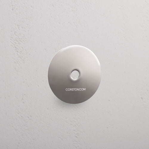 Polished Nickel sample finish disc labeled 'CORSTON.COM' displayed on a textured white background.