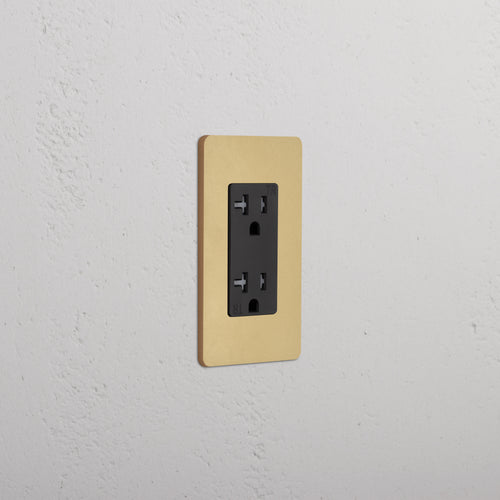 Grove 1G 20A Outlet in Antique Brass Black finish with gold trim, single socket, wall-mounted.