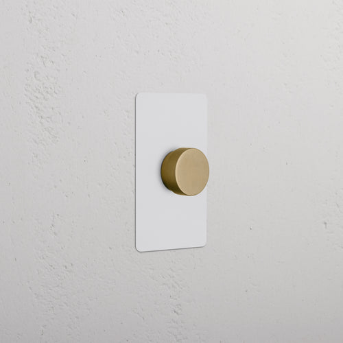 Kew 1G Dimmer Switch in paintable antique brass finish with a round knob on a rectangular plate.