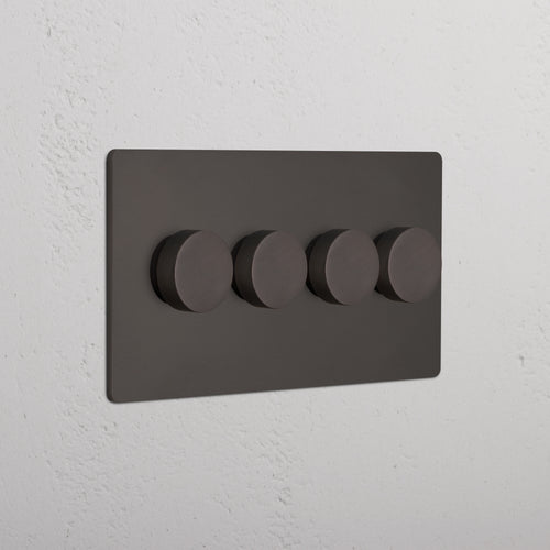 Bronze Grove 4G Dimmer Switch with four round control knobs, mounted on a white textured wall.