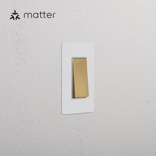 Kew 1G Smart Retractive Rocker Switch in Paintable Antique Brass White with gold switch and white plate.