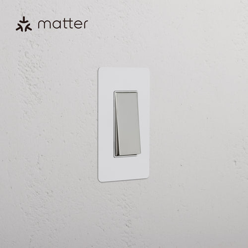 Kew 1G Smart Retractive Rocker Switch in paintable polished nickel white, shown mounted on a wall.