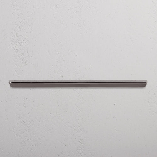 Large Oxford Furniture Handle in polished nickel, mounted horizontally on a white textured wall.