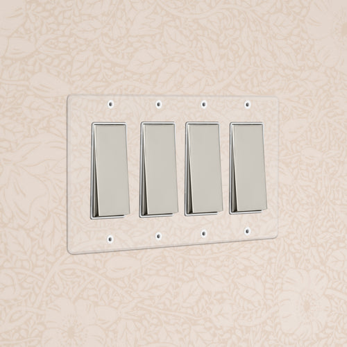Kew 4G Rocker Switch in Clear Polished Nickel White with four switches on a clear plate, wall-mounted.