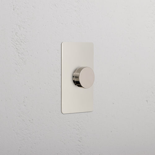Kew 1G Dimmer Switch in polished nickel with a round knob on a rectangular plate, wall-mounted.