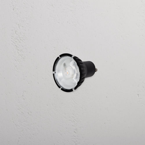 Chester 7.5W 50mm LED GU10 12° Bulb with black casing, installed in a white textured ceiling, facing down.