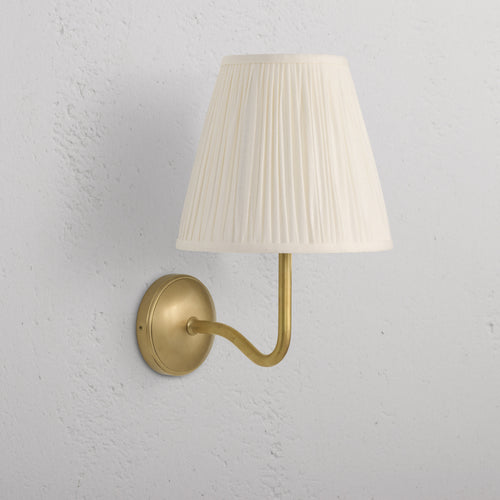 Large Malvern Wall Light in Alabaster White with antique brass finish and pleated cream lampshade, wall-mounted.