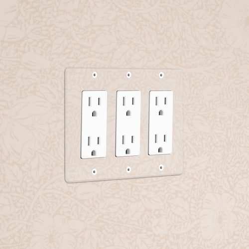 Kew 3G Outlet - Clear White electrical outlet with three sockets and a clear cover plate on a beige wall.