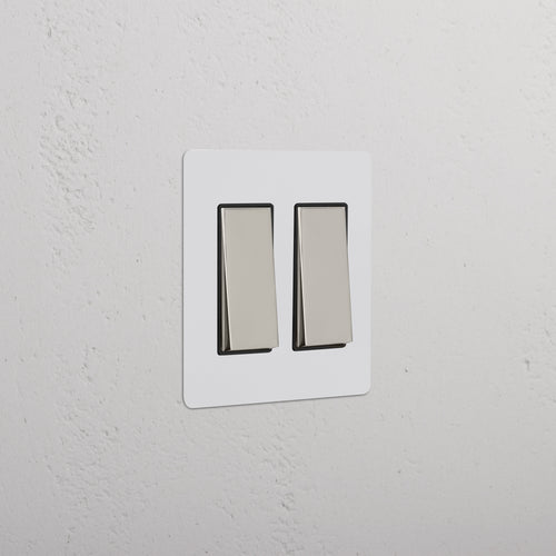 Kew 2G Rocker Switch in paintable white plate with two polished nickel black rocker switches.