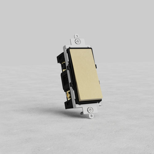 Four Way Rocker Switch in Antique Brass Black finish, shown on a gray textured surface against gray background.