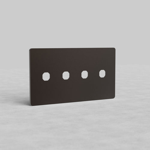 Bronze 4-gang switch plate, Grove US design, with four square cutouts, shown upright on a gray surface.