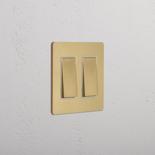 Grove 2G Rocker Switch in antique brass white with brushed gold plate and dual rocker toggles.