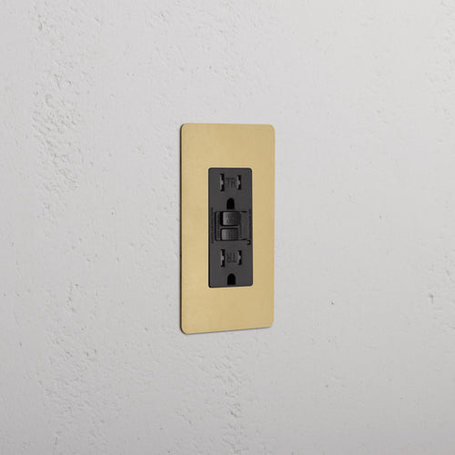 Kew 1G 15A GFCI Outlet in Antique Brass Black finish, featuring two sockets and test/reset buttons.