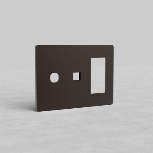 Bronze 3-gang outlet, keystone, and switch plate faceplate with three cutouts, upright on light gray surface.