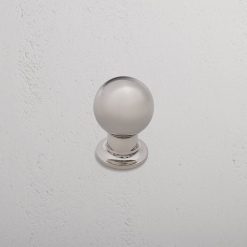 Bayswater Furniture Knob Medium in polished nickel, mounted on a textured white wall.