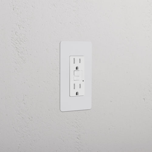 Kew 1G 15A GFCI outlet in paintable white with two sockets and reset/test buttons on a white wall.