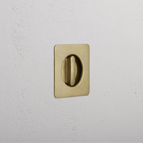 Regent Recessed Thumbturn in Antique Brass, featuring a square plate with a circular turn handle.