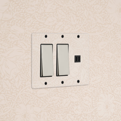 Kew 3G 2x Rocker Switch & Fast Charge USB in clear polished nickel black on a beige floral patterned wall.