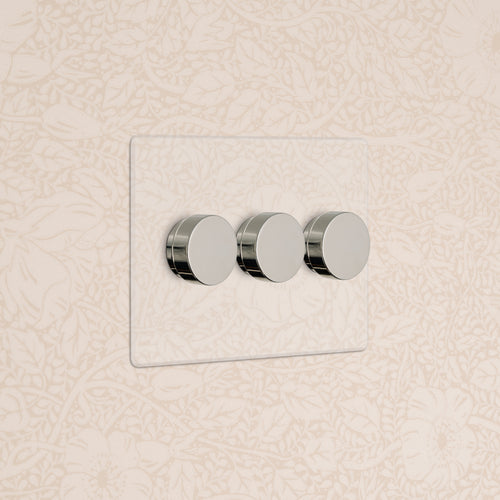 Kew 3G Dimmer Switch in Clear Polished Nickel with three round dials, mounted on a wall.
