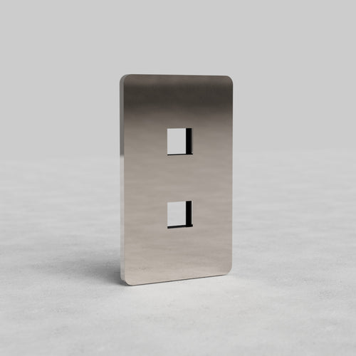 Polished nickel 1G 2x Keystone Plate Grove US with two vertical keystone slots on a light gray surface.