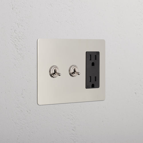 Kew 3G 2x Toggle Switch & Outlet in Polished Nickel Black with two toggles and a double outlet on a wall.