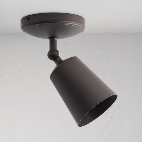 Baylis Single 70mm Spotlight in bronze finish, conical shade, ceiling-mounted and angled for focused lighting.