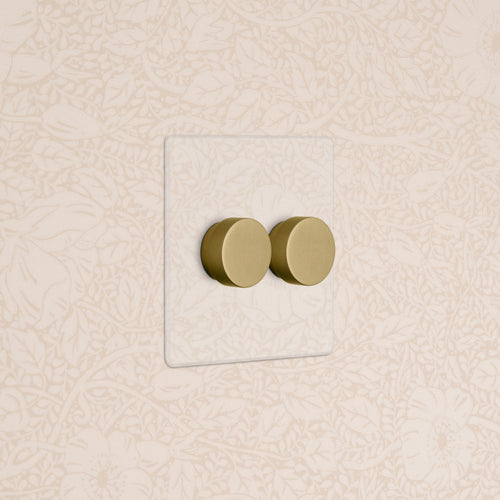 Kew 2G Dimmer Switch in clear antique brass finish, double round knobs on a rectangular plate.