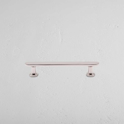 Milliner Furniture Handle Small in polished nickel finish with rounded ends, mounted on a white surface.