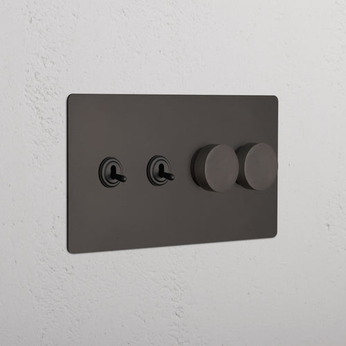 Bronze Kew 4G switch with two toggle switches and two dimmer knobs on a wall plate.