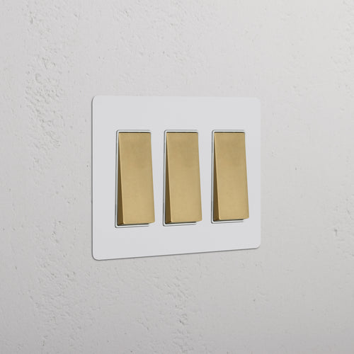 Kew 3G Rocker Switch in paintable antique brass white with three switches on a rectangular plate.