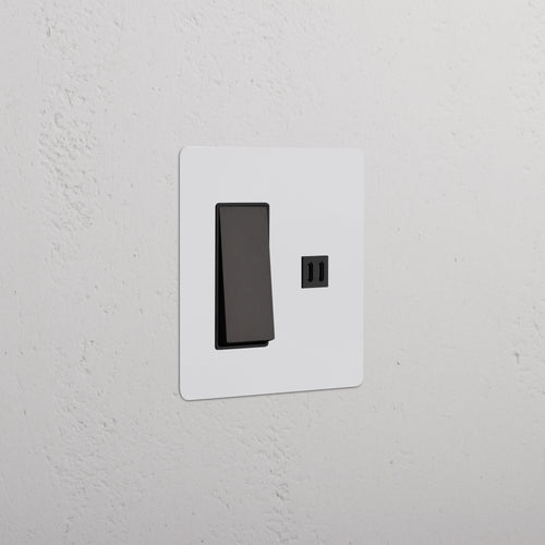 Kew 2G Rocker Switch with Fast Charge USB in Paintable Bronze Black, shown installed on a white wall.