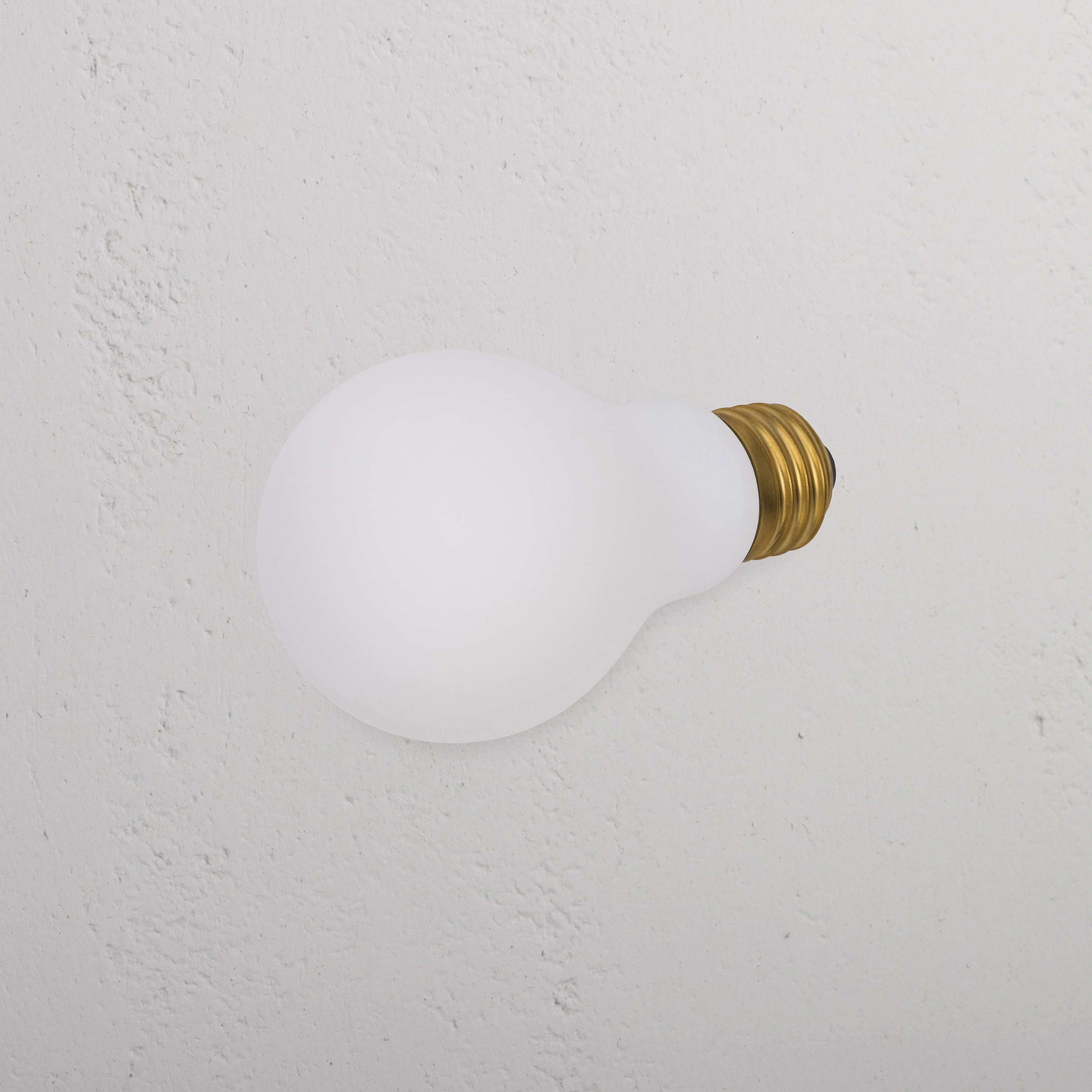 Mulberry 6W LED E26 light bulb with brass screw base resting on a textured white background.