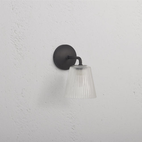 Richmond Medium Wall Light Fluted Glass in bronze with ribbed glass shade and bronze base, wall-mounted.