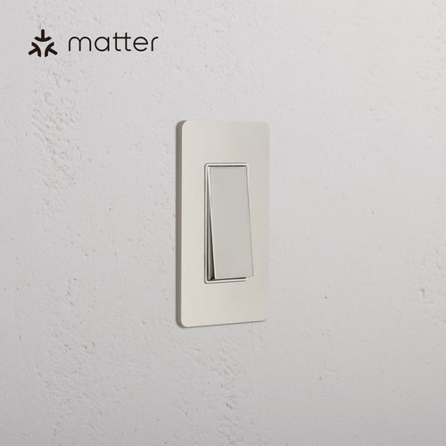 Grove 1G Smart Retractive Rocker Switch in Polished Nickel White, mounted on a white textured wall.