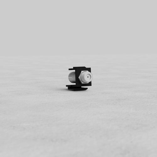 Black Satellite Keystone Module for structured cabling, shown on a light gray surface with a plain background.