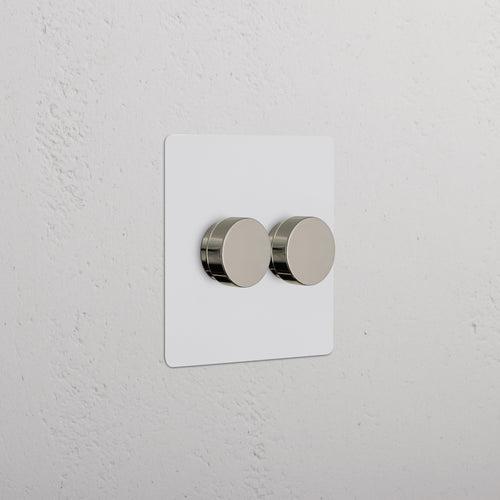 Kew 2G Dimmer Switch with two paintable polished nickel knobs on a white rectangular plate.