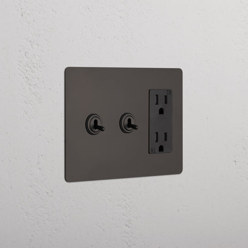 Kew 3G 2x Toggle Switch & Outlet in Bronze Black with two toggles and a double outlet on a wall plate.