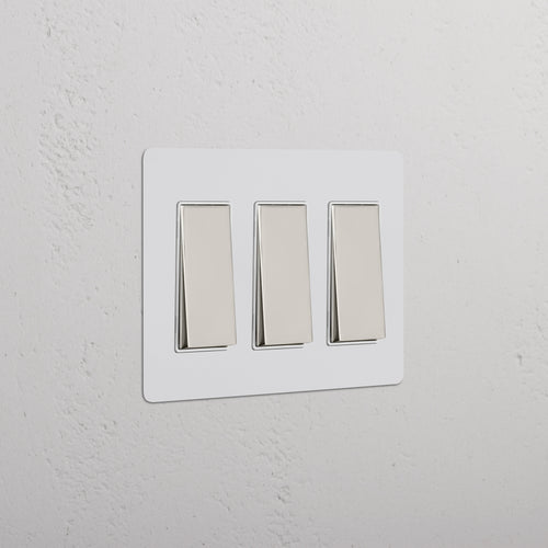 Kew 3G Rocker Switch in paintable polished nickel white finish with three rectangular rocker switches.